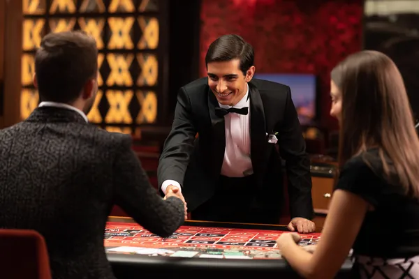 A woman in a luxurious green gown next to an ornate roulette wheel, capturing the upscale casino mood of TTTJILI.